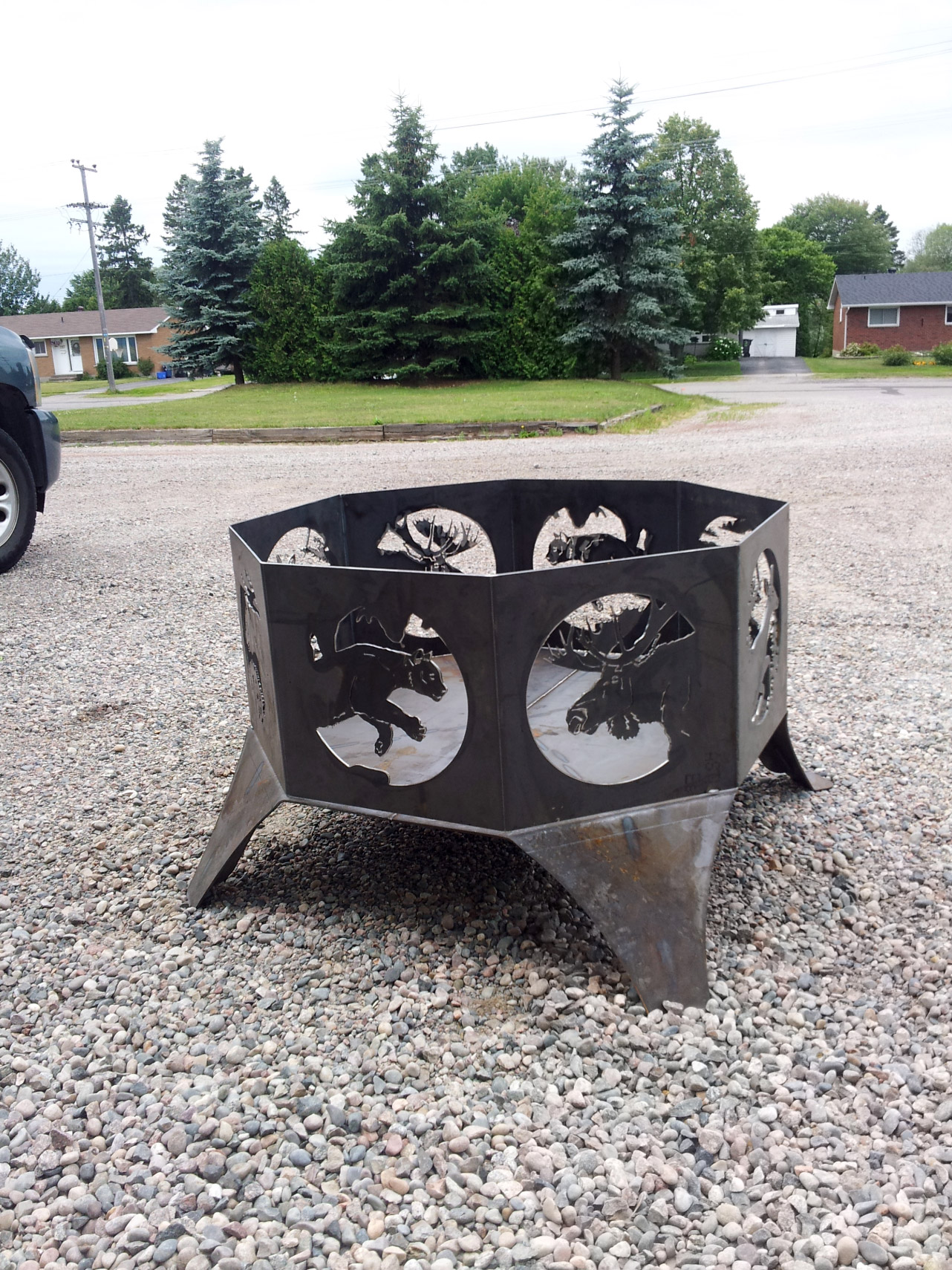 Customized large steel firepit with Northern wildlife cutouts